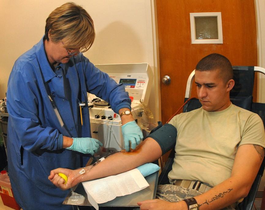 OFFUTT AIR FORCE BASE, Neb.,- Mrs. Audrey Flekke from the American Red Cross checks on Airman 1st Class Evan Cater, a medical record technician from the 55th Medical Operations Squadron, while he donates blood Nov. 07. Airman Cater is known as a “double red donor” because he is donating more plasma then other participants. The American Red Cross’ goal for this blood drive was 38 units of blood. Photo By: Mr. Charles Haymond