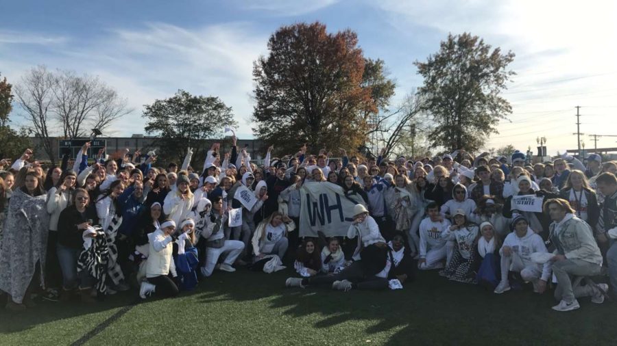 The+WHS+student+section+poses+for+a+picture+after+the+WHS+boys+soccer+team+win+against+Harrisonville+Nov.+10.+Its+super+exciting+since+its+my+last+year%2C%E2%80%9D+senior+Bria+Hasenjaeger+said.+%E2%80%9CAll+these+kids+coming+to+support+the+soccer+team+makes+this+one+of+the+most+memorable+moments+of+high+school.%E2%80%9D+The+theme+for+the+game+was+white+out+because+the+boys+soccer+team+was+wearing+their+white+jerseys.