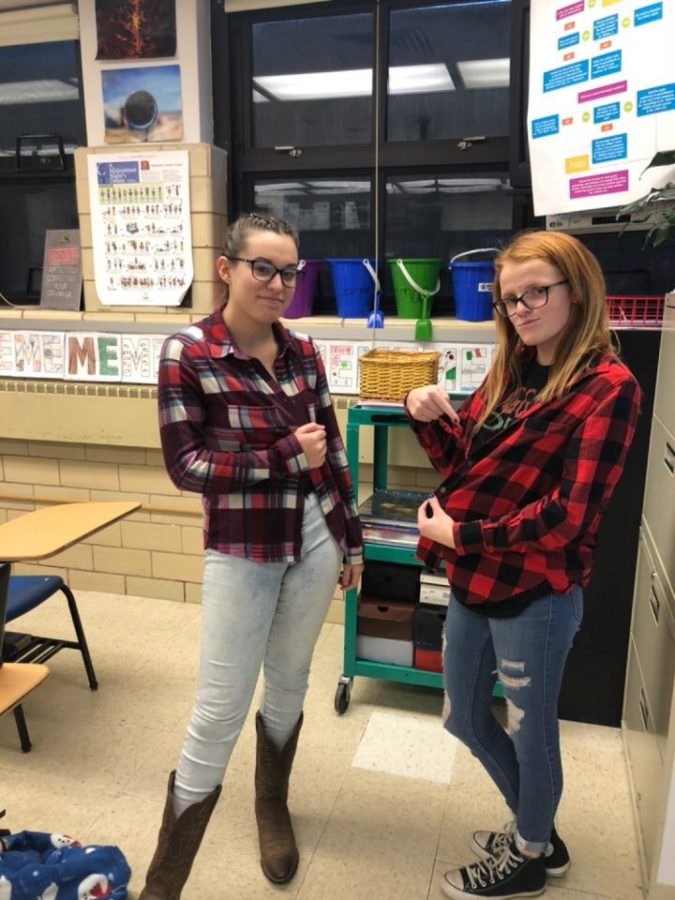 Hannah Belcher (left) and Hannah Jackson (right) pose for the camera, showing off their flannels.