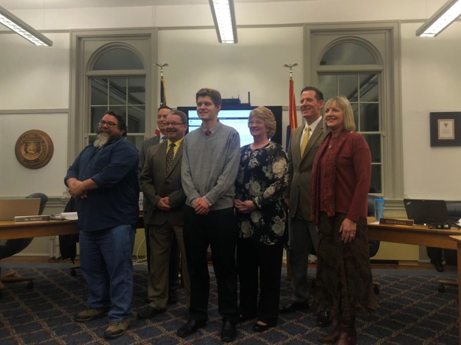 Junior Tristan Zeh poses with the Board of Education after he is sworn in as the 2019 student board representative Jan. 23. “It was very interesting in getting to see the reports they give, how the superintendents report to the board members and how that administrative side of running things look,” Zeh said. Pictured from left to right is Kevin Blackburn, John Freitag, Scott Byrne, Zeh, Trish Mitchell, Bob Oreskovic and Susan Thatcher.