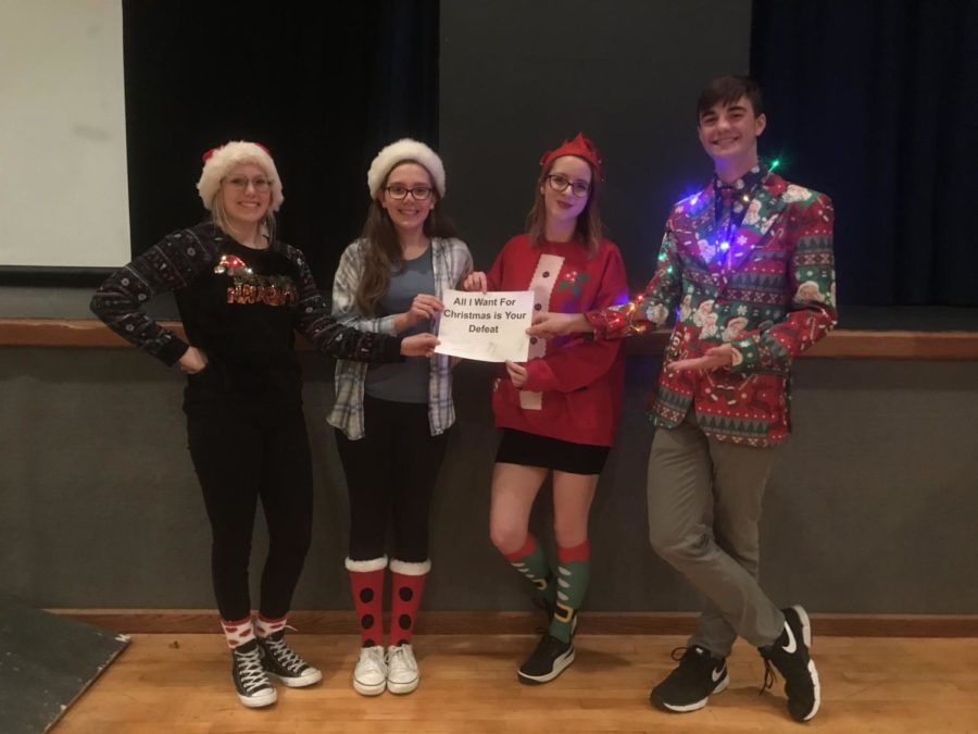 Pictured above are members of the winning team, “All I Want for Christmas is Your Defeat.” From left, are senior Sebastian Secor, sophomore Samantha Doepker, senior Audrey Bush and senior Ian Maloney. “Every year I get so excited because it’s the one time I get to show off my catalogue of semi-useless facts,” Bush said. “Doing it in front of the whole school is both awesome and nerve-wracking.” Along with placing first against students, the team also defeated an all teacher team.