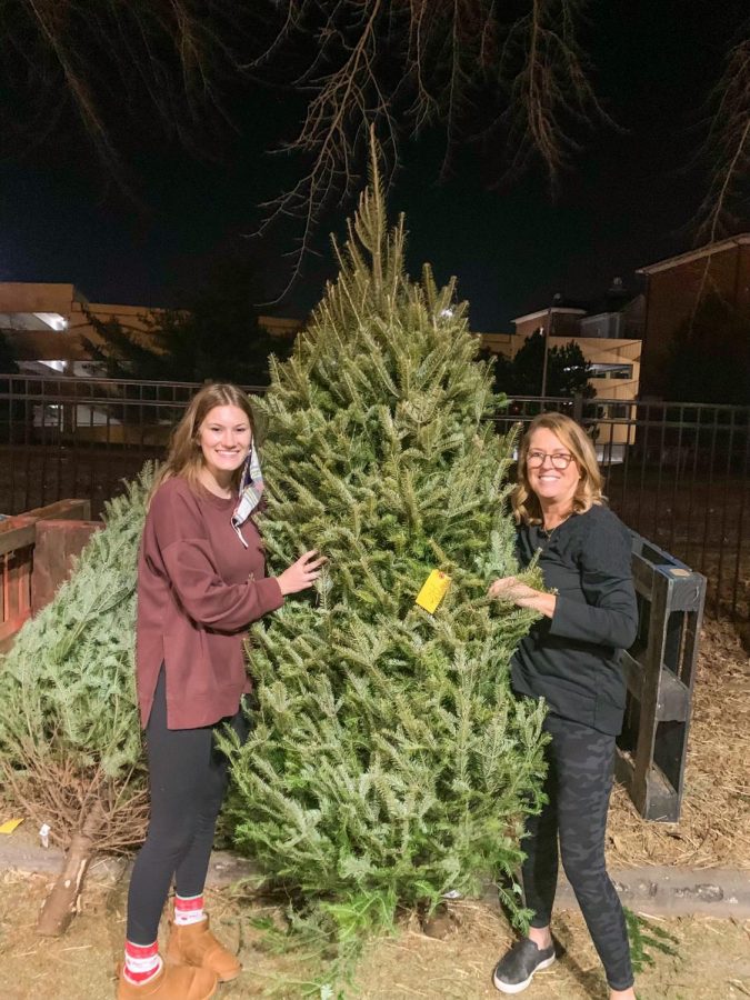 Natalie Nothum poses with her mom after picking out their Christmas tree. I love seeing all the homemade ornaments with all my siblings names on it every year, Nothum said. Nothum got her Christmas tree in Kirkwood this year. 