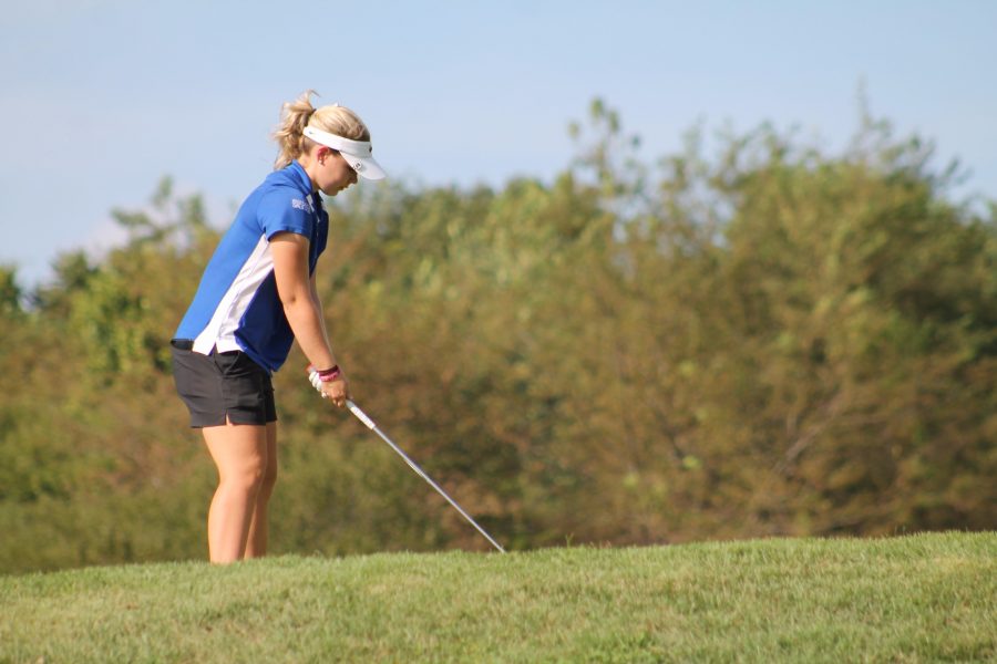 Preparing to swing, senior Sydney Parrish participates in a home meet Sept. 7. "On the first tee, I feel very anxious and I'm nervous, but I always take a deep breath and calm myself down," Parrish said. The girls golf team placed first.