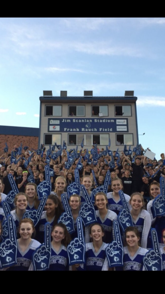 The WHS cheerleaders and student section pose with the spirit fingers donated by Bank of Washington. On Aug. 18, WHS football team lost 14-43 to the Union Wildcats. The #FlockNation has been used to spread awareness of the name change on social media platforms.