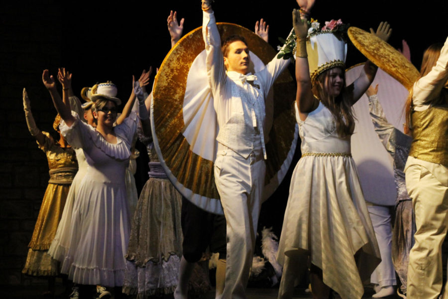 Freshman Maelana Baker, senior Noah Kresse and freshman Hayley Pecka (left to right) perform during the fall musical "Beauty and the Beast" Nov. 9. “Everyone there is all pretty chill with each other,” Pecka said. “We can all goof off and say what we want.” The cast began rehearsal during the first week of school.