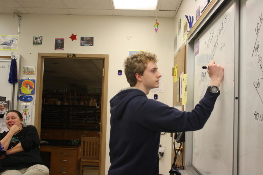 Junior David Walker writes an equation on the board. “It’s definitely teacher led," Walker said. "Students in that class (Engineering), we’ll do our own projects and things, but it’s not any sort of an open form type of class. They’ll tell you what to do, you just have your own way of doing it.” Walker is in his second year of engineering at WHS.