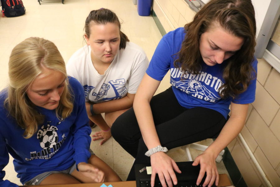 Seniors Haley Oetterer, Jennifer Borgmann and Josie Kleinheider work to send out messages to the Homecoming court. "My favorite part of Leadership is having the ability to be behind the scenes in all the school events," Kleinheider said. Students have the option to choose the events they work on throughout the year.