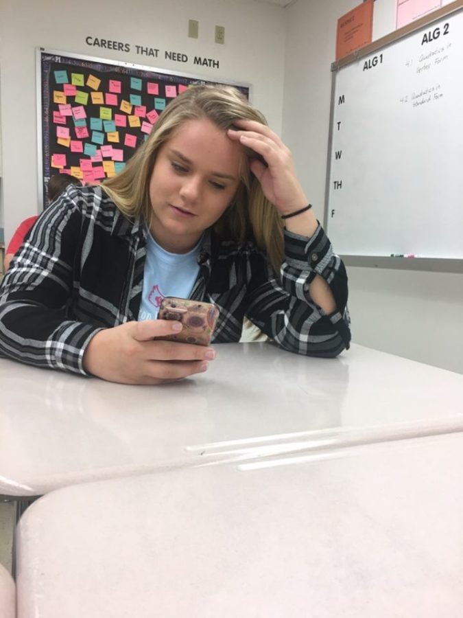 Junior Isabel Kimminau sits on her phone during the first day of EPIC hour Oct. 17. "It's actually really boring. I don't get the point of it now, but I feel like it could help us in the long run," Kimminau said. WHS's next EPIC Hour is Nov. 7.