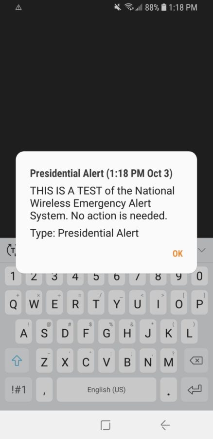 The Presidential Alert appears across the screen of a WHS teacher's cell phone screen. 