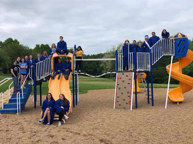 Senior Joseph Bauer and other WHS seniors pose for a picture on the Marthasville Elementary School playground. “The final picture of all of us on the playgrounds we used to play on as kids was probably the most memorable,” Bauer said. Bauer still keeps in touch with his former elementary school classmates.
