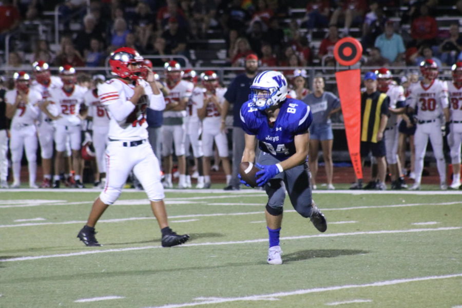 Junior Ryan Hoerstkamp catches a pass at the game against Liberty High School Friday, Sept. 27. "It's nice to actually win a Homecoming game...it's just confidence," Hoerstkamp said. Hoerstkamp is looking forward to playoffs and districts.