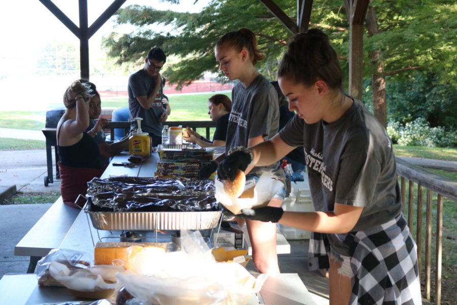 Students get food and enjoy the tailgate before the Homecoming game against Liberty Sept. 27. “I think people should come to the tailgates because it’s just fun overall, it’s just something to do,” senior Matthew Amlong said. “And sometimes we’ll have food there, and who doesn’t wanna get some grilled hot dogs?” The WHS student section have been doing tailgates since the first away football game.