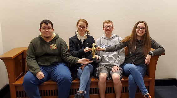 A WHS scholar bowl team poses with their fourth place trophy at Washington University on Feb. 15. “Mr. Dennis puts it like this: 'Pick a subject, learn it, know it, hit the button,'” sophomore Silas Clements said. This same day, senior Audrey Bush was awarded with a 10th place scoring medal from the preliminary bracket. 