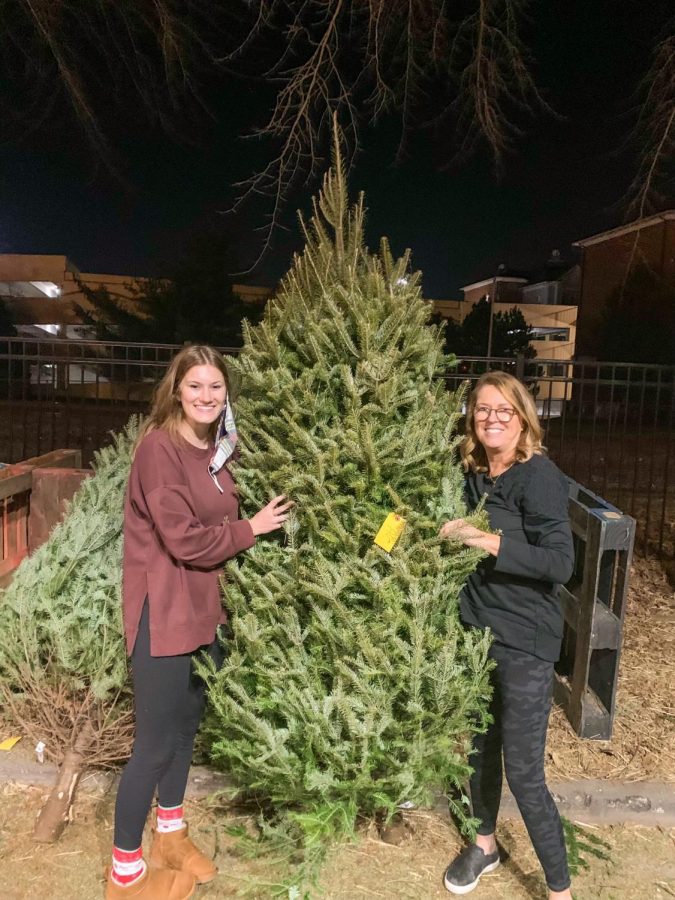 Natalie Nothum poses with her mom after picking out their Christmas tree. "I love seeing all the homemade ornaments with all my siblings' names on it every year," Nothum said. Nothum got her Christmas tree in Kirkwood this year. 