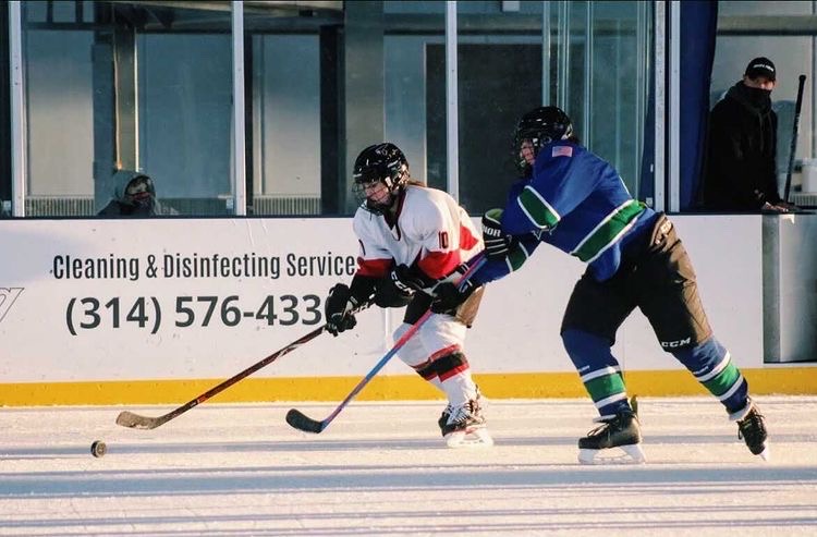 Sophomore Maci Rohlfing battles for possession during one of her hockey matches. "I love how rough and fast-paced hockey is," Rohlfing said. Rohlfing plays right wing for the Chesterfield Falcons ice hockey team.