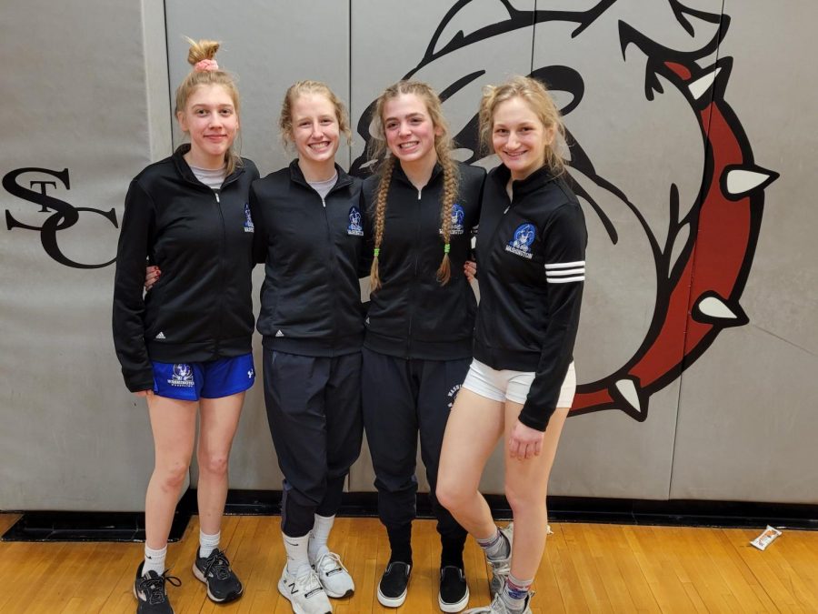 From left, sophomore Julia Donnelly, senior Mia Reed, senior McKenna Deckelman and senior Allison Meyer stand together for a picture after qualifying for state. 