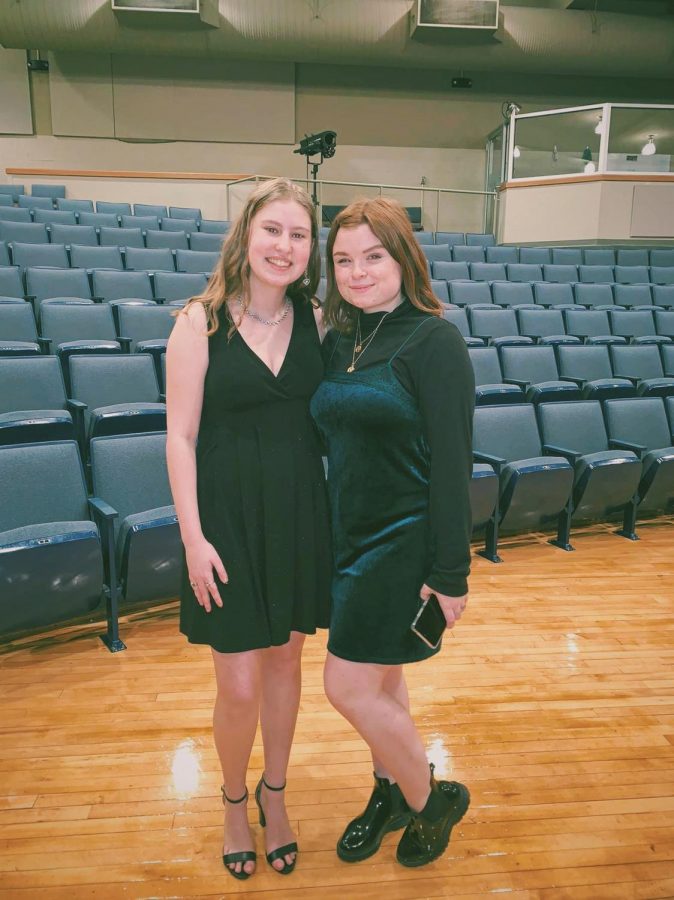 Seniors Emma Hillermann and Kaylie Rowe pose for a picture after their solos at their live concert March 10. “'The Sky Above the Roof' was my favorite song because it contained lots of range, but it was also more relatable and was more me," Hillermann said. This will be Hillermann and Rowe's last year in choir. 