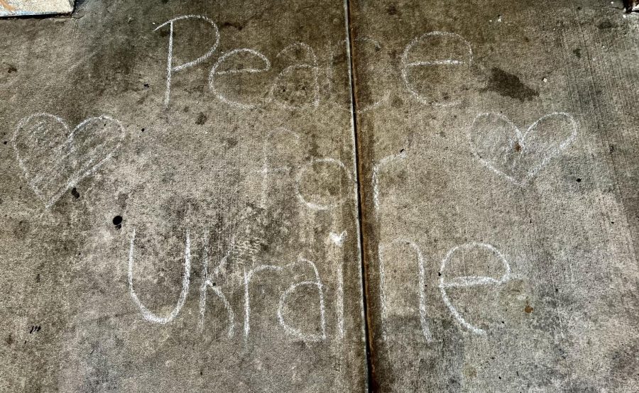 WHS students write messages of support for Ukraine outside of Northington Lobby during a peace vigil hosted by Community Advocates on Friday, March 4. "[Students] were able to just gather in a safe space to maybe think and reflect about what the Ukrainian people [are] going through," said WHS Community Advocates advisor Kerri Flynn. The event also raised money to support the Ukrainian refugees.  