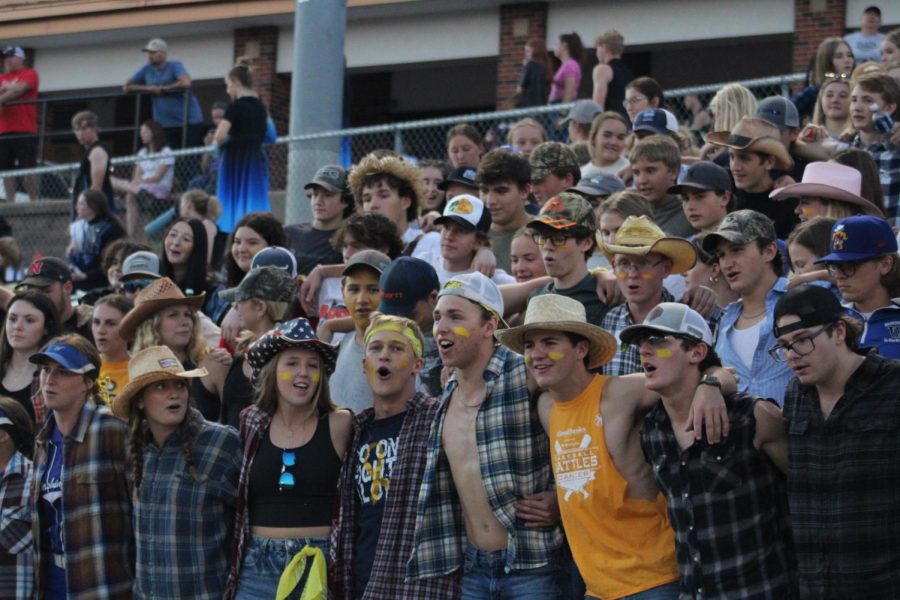 The Flock leaders (front) cheer on the Washington Blue Jay Varsity football team against Holt for "Hick Night" on September 8th, 2022. "We all come up with [theme] ideas that haven't really been done before," said Inman.