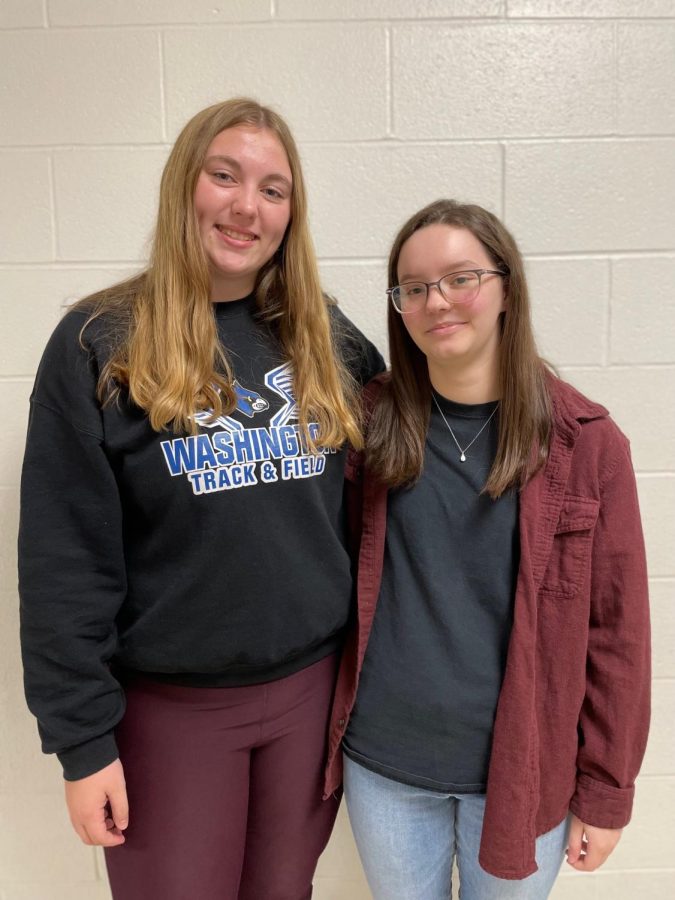 Alyssa Repke and Teagan Zeh pose for a picture. "I feel like [people] would be a lot more stressed out if we weren't there." Repke said.  They enjoyed managing the cross country team this year.