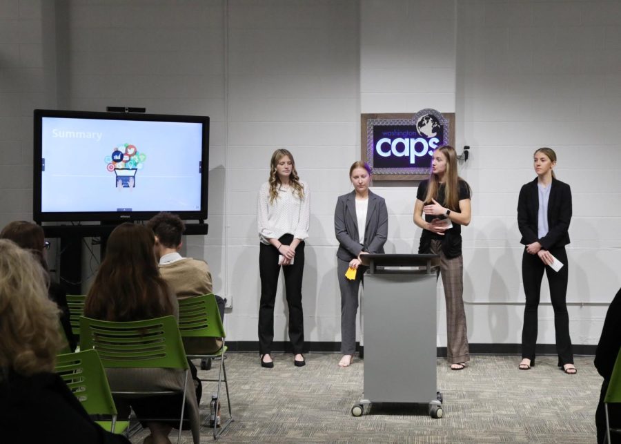 Juniors Olivia Zastrow (far left), Alayna Royal (second left), Abigail Gilliat ( second right) and Jillian Huellinghoff (far right) are presenting their social media campaign to the directors on the board of Downtown Washington.