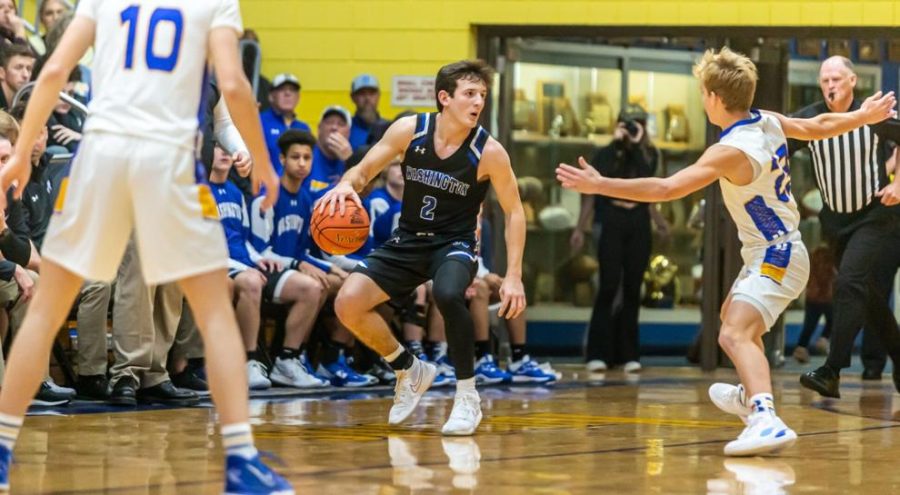 Washington's Sam Paule carries the ball down the court facing Borgia's Tate Marquart at the 70th Annual Turkey Tournament